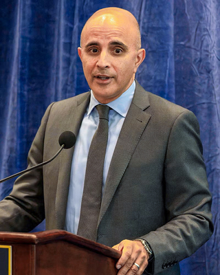 Dr. Khanna, orthopedic surgeon, speaks at a podium.