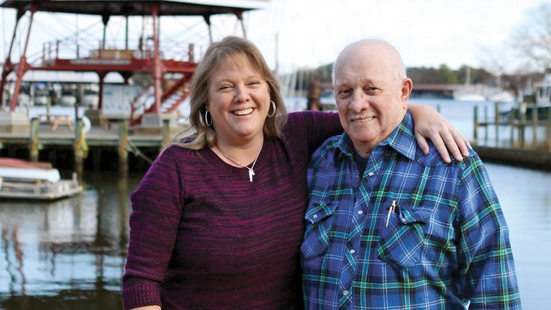 Janet Langley and her father J.C. Tubbs stand on the dock in a marina.