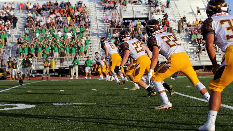 A football team lines up for kickoff on a football field.