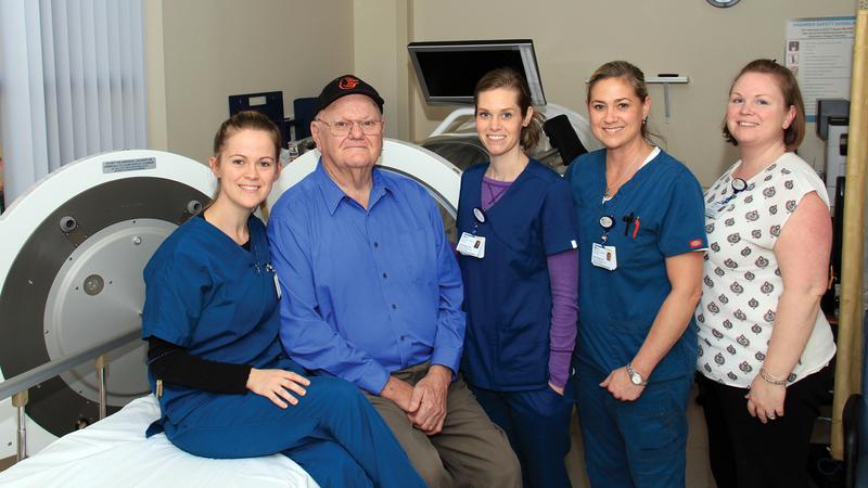 A patient poses for a photo with a team of care providers from MedStar Health's wound healing center.