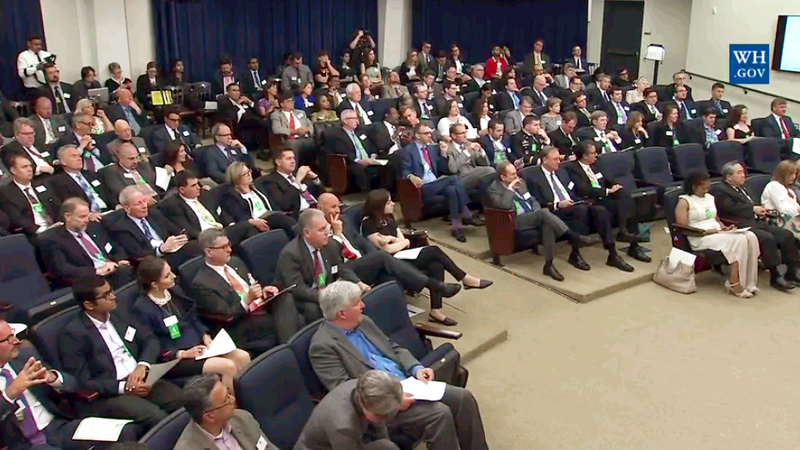 Audience at the White house listening to a speaker.