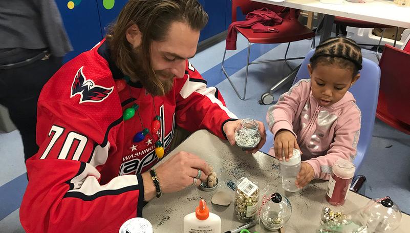 Washington Capitols player Braden Holtby works on an activity with a pediatric patient at MedStar National Rehabilitation Hospital during a visit.