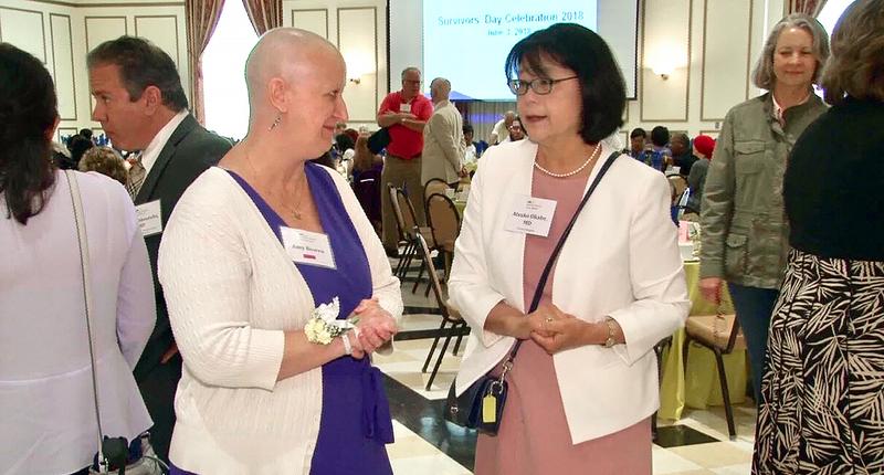 Dr Okabe talks with a patient at a 2019 Survivors Day event at MedStar Health.