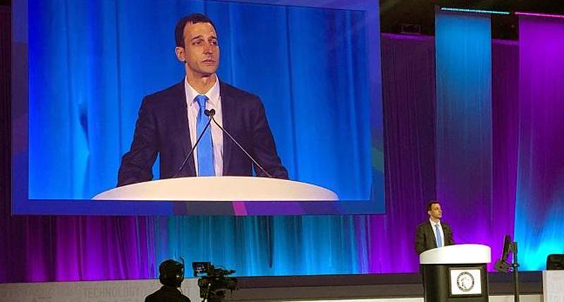 Frederico Asch speaks at a podium during a professional conference.