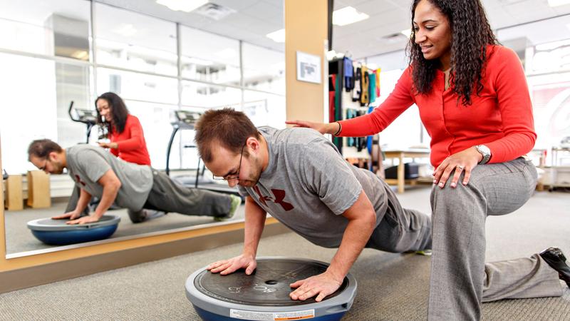 A MedStar Health physical therapist helps a patient during a therapy session.