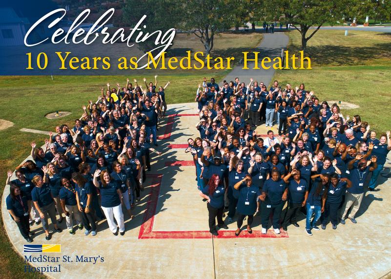 A team of heathcare professionals from MedStar St Mary's Hospital poses for a large group photo on the hospital's helipad.