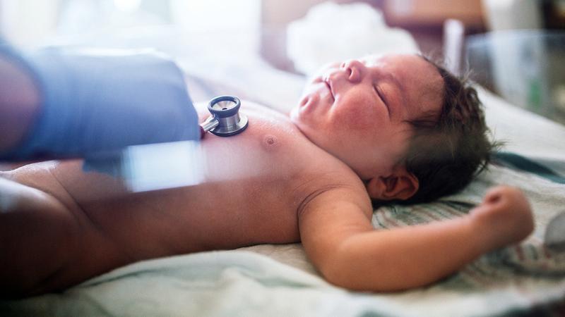 A newborn in an incubator.