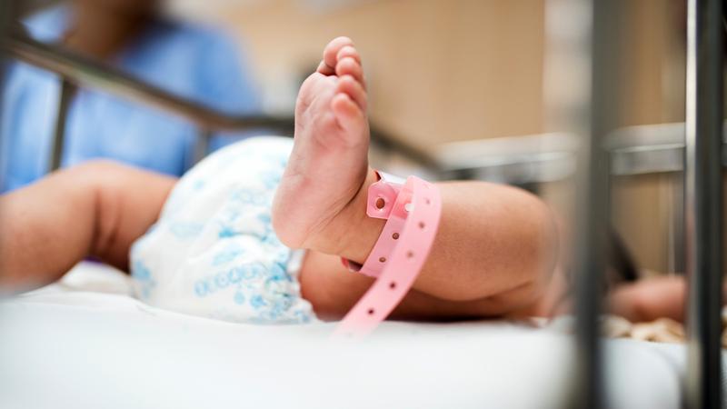 Close up of an infant's foot in a hospital nursery.