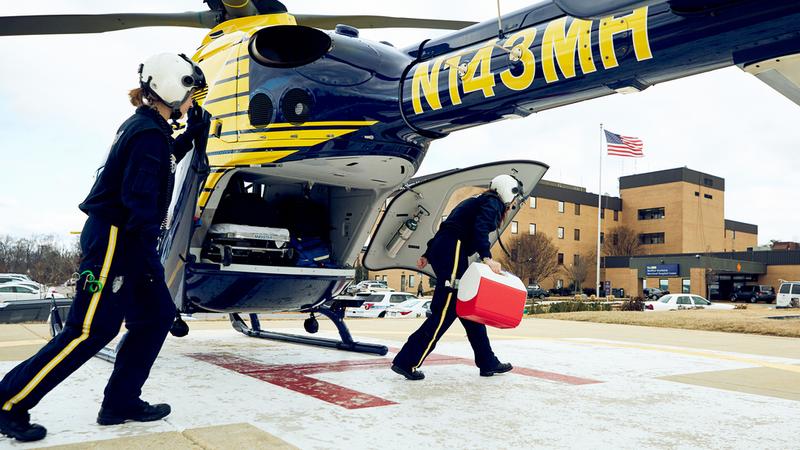A flight nurse steps out of the MedStar Healicopter to deliver organs for transplant at MedStar Southern Maryland Hospital Center. 