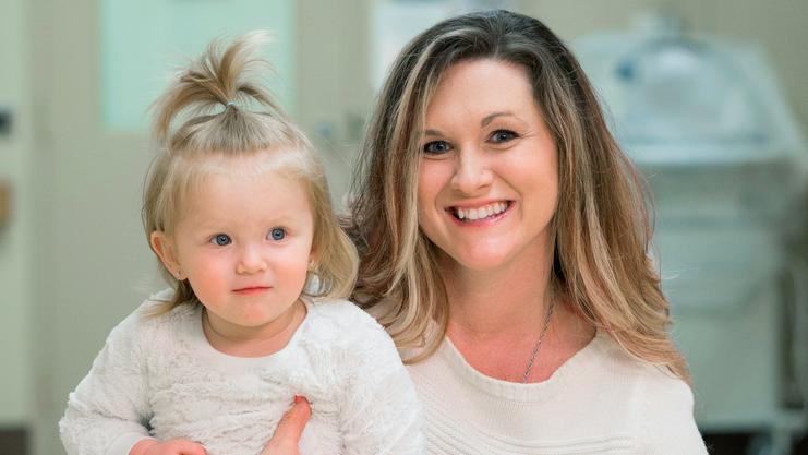 Melanie Bush and her 2 young children pose for a photo in a hospital hallway at MedStar Health.