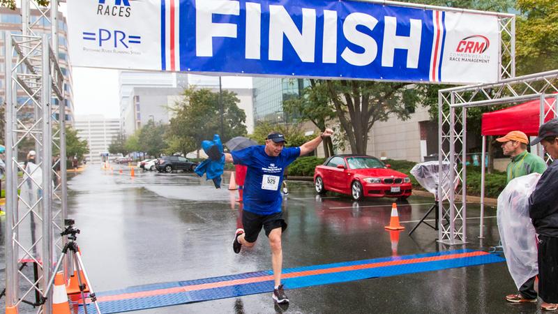 A runner crosses the finish line in the 2018 Super H Run Walk Cycle event.