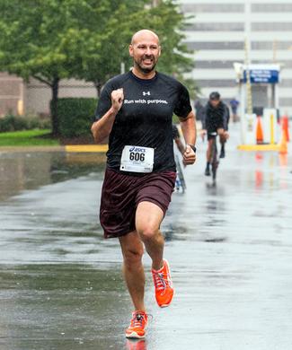 A runner crosses participates in the 2018 Super H Run Walk Cycle event.
