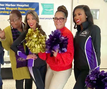 Baltimore Ravens cheerleaders pay a visit to nurses at MedStar Harbor Hospital during Nurses Week.