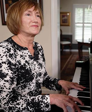 Lisa Emenhieser plays piano after undergoing successful hand surgery at MedStar Health.