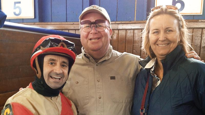 Steven Moyer, burn survivor, in his element with his sister and champion rider Joe Bravo in the paddock at Laurel racetrack prior to a race.
