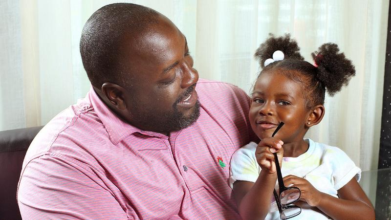 Theodore Smith sits with his daughter after undergoing successful eye surgery at MedStar Health.