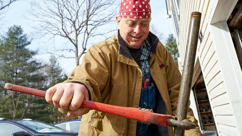 Alan Hunsberger tightens a pipe fitting at his job as a plumber.
