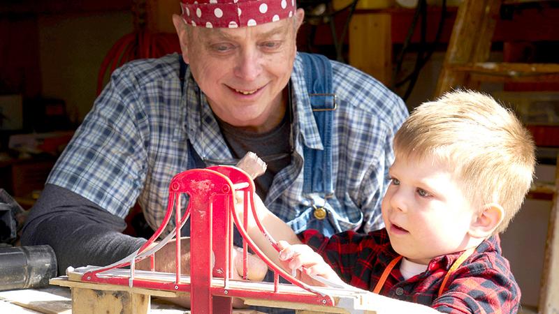 Alan Hunsberger works on a building project with his young grandson.