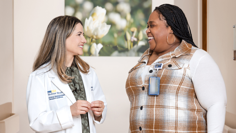 Dr. Nitika Paudel talks with a fellow healthcare colleage at MedStar Health.