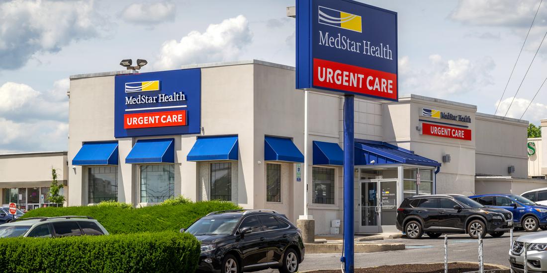 Side of the white MedStar Health Urgent Care building with blue awnings in Catonsville, Maryland