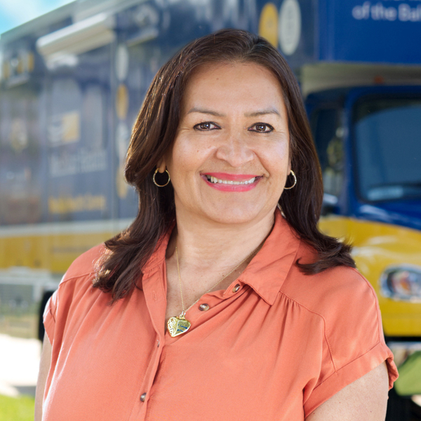 Carmen Valez, MedStar Health mobile healthcare team member, poses for a photo in front of the mobile healthcare center truck.