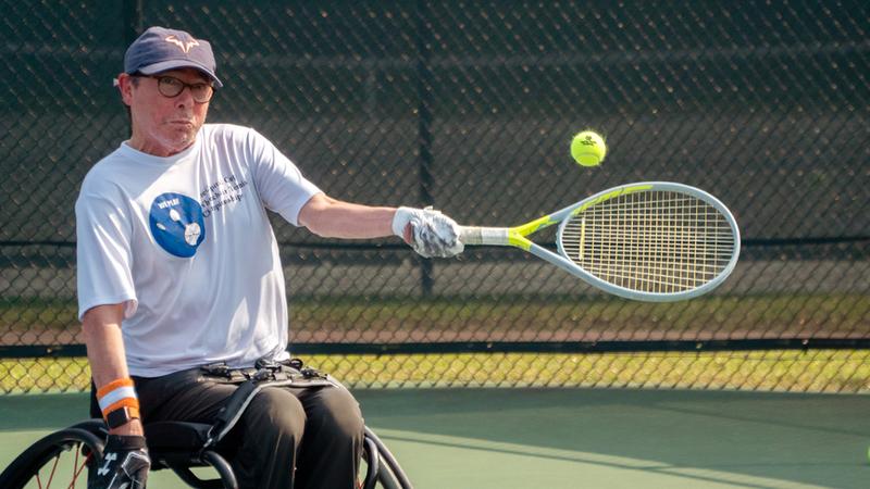 A man plays wheelchair tennis as part of MedStar Health's adaptive fitness program.