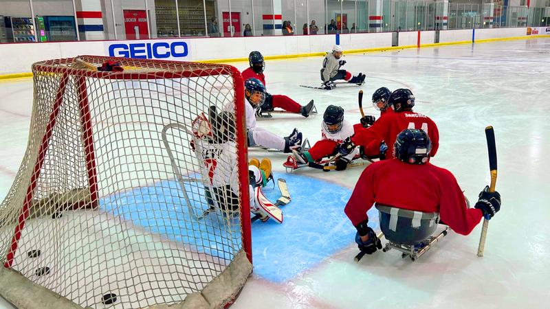 A group of kids play ice hockey on sleds as part of MedStar Health's Adaptive Fitness program.