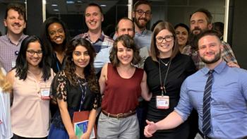 Adult Psychiatry Residency program residents stand together on a stairway.