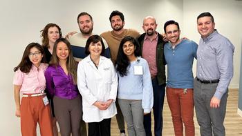 Adult Psychiatry Residency program residents stand together on a stairway.