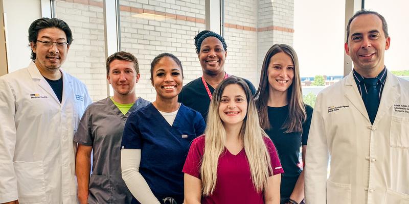 The Bariatric Surgery team in Baltimore stands together for a group photo inside the surgery center office.