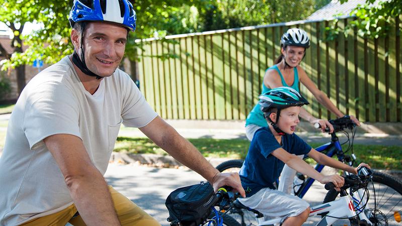 A family rides bikes outdoors.