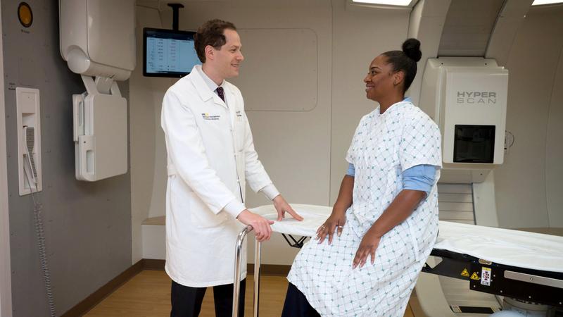 Dr Keith Unger consults with a female patient in the Proton Therapy center.