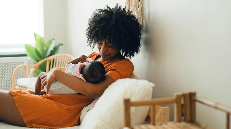 A mother holds her newborn baby.