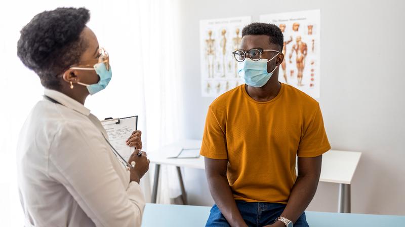 A man talks with his doctor during an office visit.