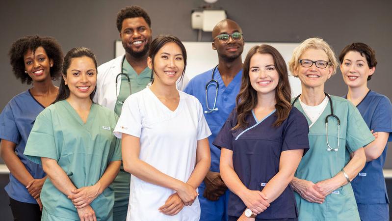 A group of healthcare professionals poses for a group portrait.