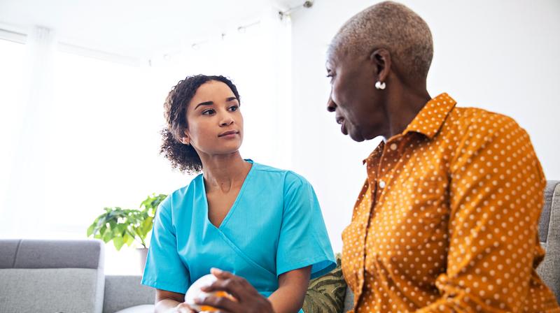 A nurse talks with a patient.