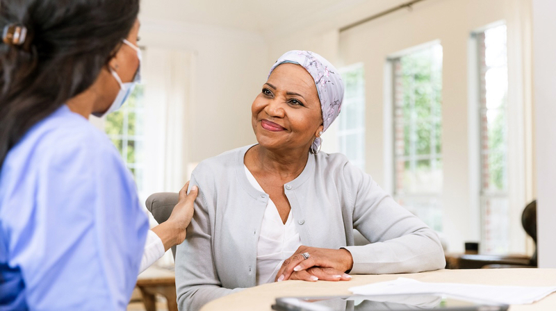 A cancer patient talks with a nurse