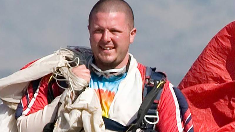 Joshua Nahum, pictured carrying his parachute after a skydive.
