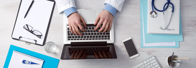 Detail photo of hands on a laptop computer.