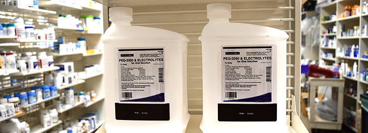 Closeup photo of bottles of colonoscopy prep liquids on a pharmacy shelf.