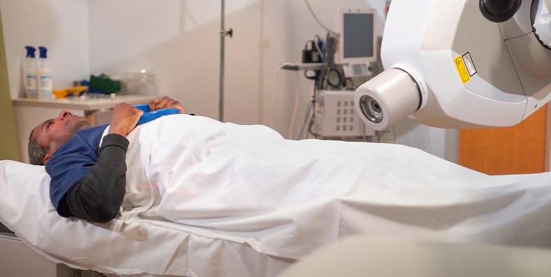 A male patient lays on a table in the Cyberknife Center at MedStar Georgetown University Hospital awaiting treatment.