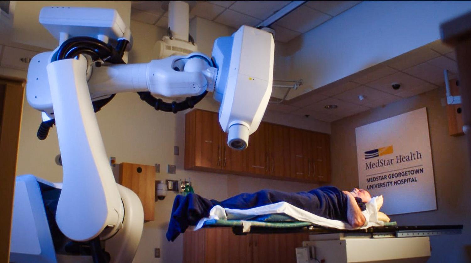 A male patient lays on a table in the Cyberknife Center at MedStar Georgetown University Hospital awaiting treatment.