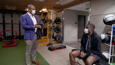 Dr Wiemi Douoguih works with professional tennis player Frances Tiafoe at a MedStar Health rehabilitation gym.