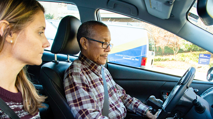 A rehabilitation therapist and a patient sit in a car during a driver rehabililtation training session at MedStar National Rehabilitation Hospital.