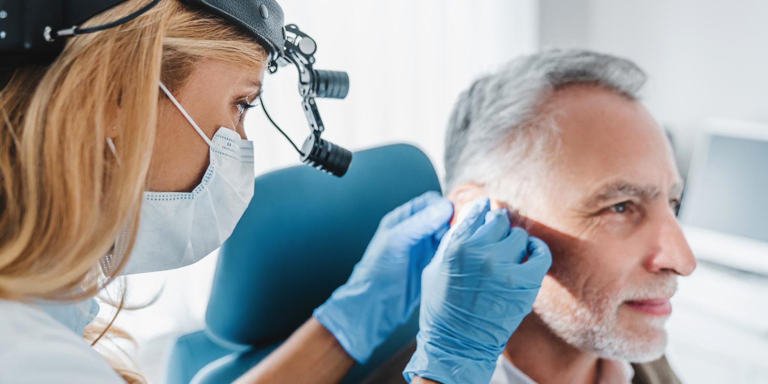 Close-up of a doctor examining a patient's ear