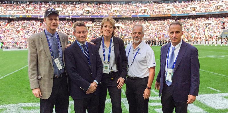 The MedStar Health physician team for the Baltimore Ravens football team poses for a photo on the field before a game.