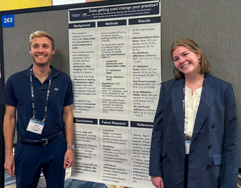 Students from the Emergency Medicine Residency Program at MedStar Health pose near an abstract presentation.