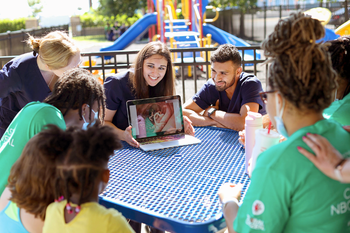 Residents teach community members at a playground.