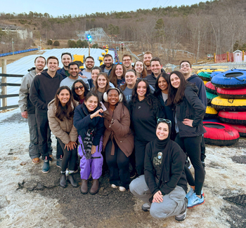 Group photo of residents outdoors at winter retreat.