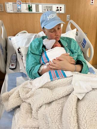 Erica Lucca Wish holds her newborn baby after successfully undergoing treatment for cancer during her pregnancy.